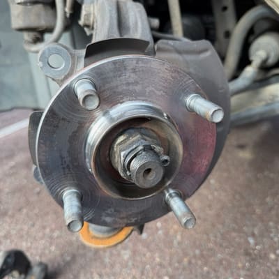 The same hub face cleaned back to bright bare metal, ready for the new rotor