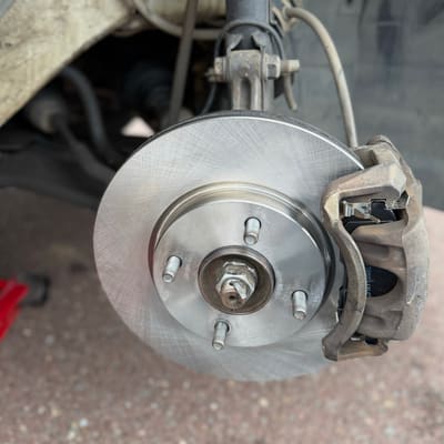 The same corner with a new brake rotor and new pads fitted